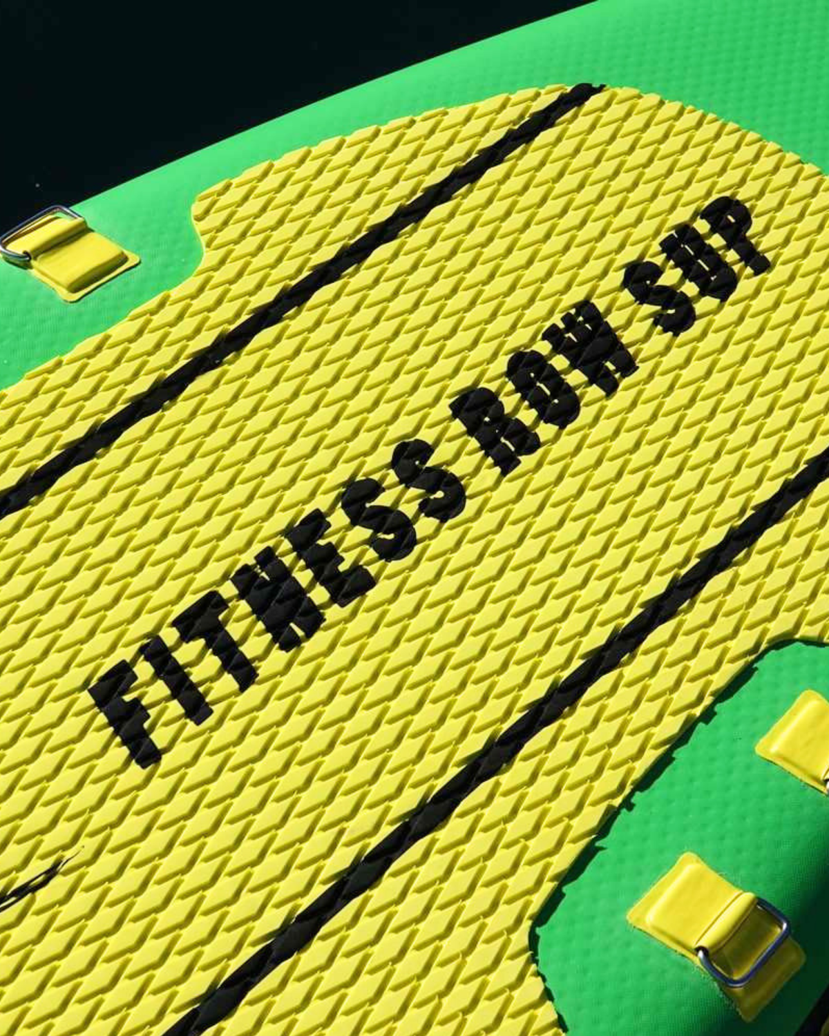 Close up photograph showing a bright yellow foam pad the "FITNESS ROW SUP' branded in black lettering.