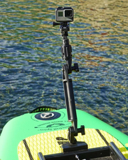 A black adjustable mounting pole with a mounted GoPro camera, shown attached to the front of a green and yellow paddle board on water.
