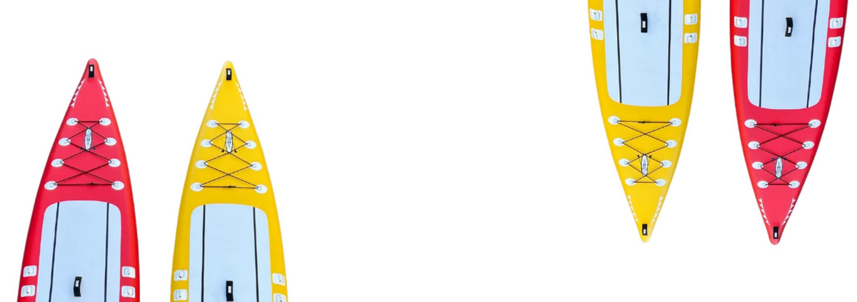 The bow of red and yellow stand up paddle boards on a white background.