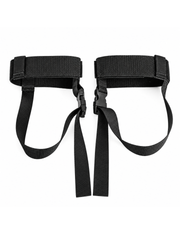 A pair of black nylon foot straps with quick-release plastic buckles, laid flat on a white background.