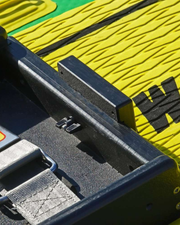 Close-up of mount attached to a molded black fixture on a bright yellow and green textured surface.