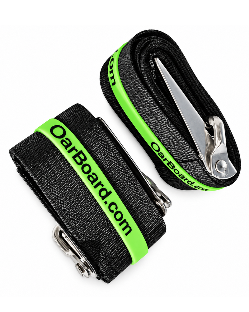 Two black woven straps with bright green trim and silver metal buckles, printed with the brand name 'OarBoard.com', on a white background.