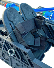 Close up of rowing kit black molded footrest with adjustable heel straps.